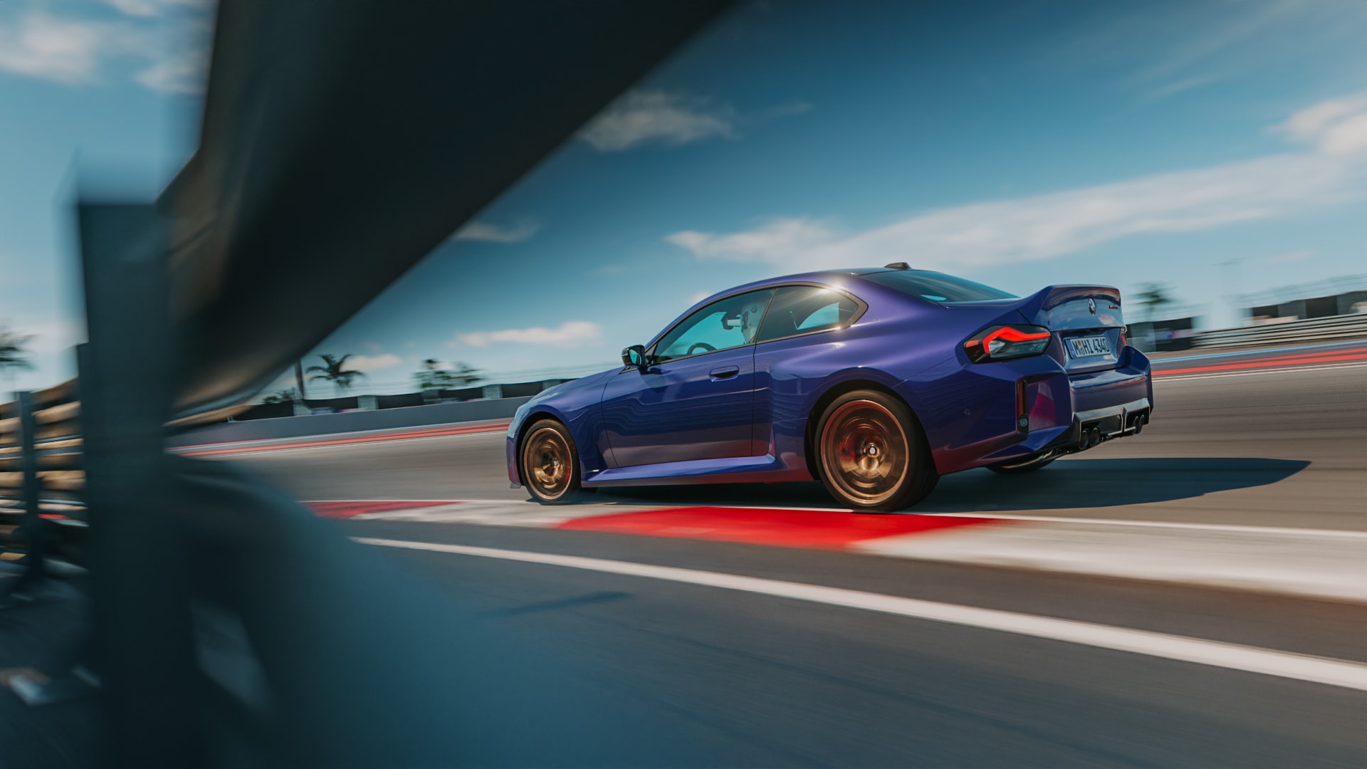 BMW M2 CS in Velvet Blue metallic driving on a racetrack