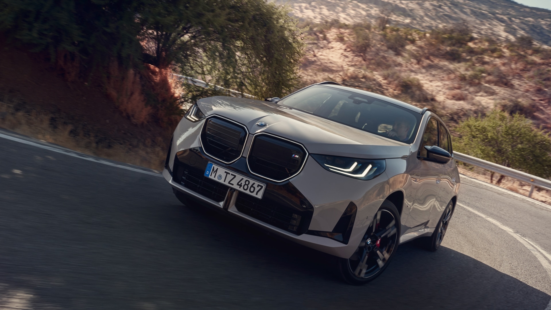 BMW X3 M50 xDrive driving on a mountain street