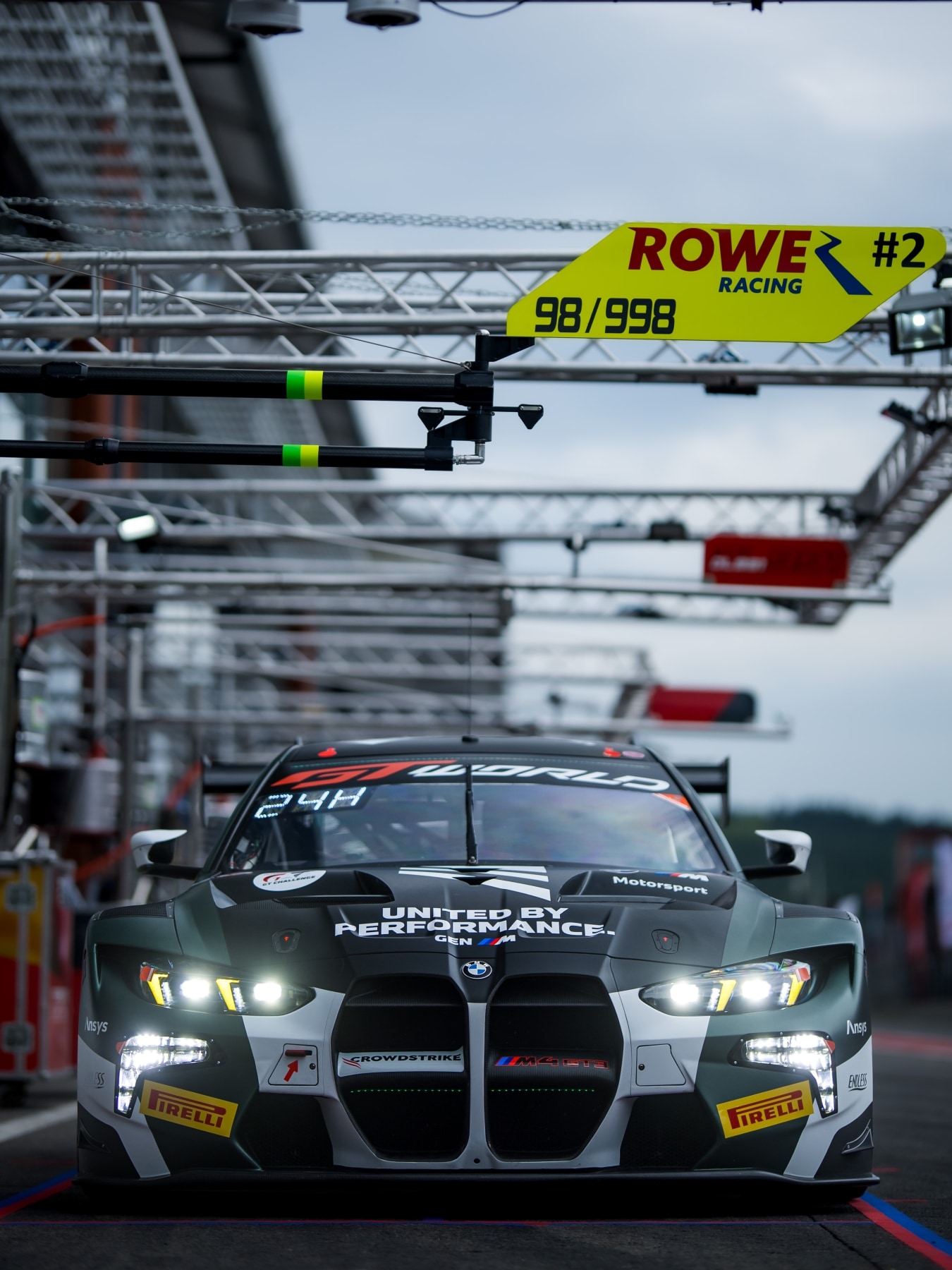 BMW M4 GT3 EVO of Rowe Racing with GEN M livery in the pit of Le Mans