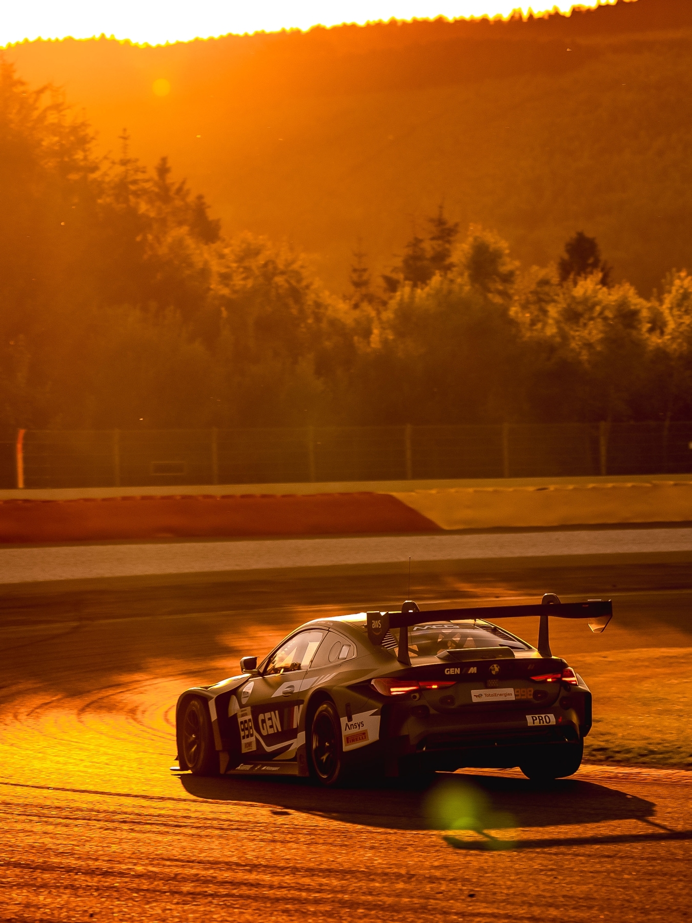 BMW M4 GT3 EVO of Rowe Racing with GEN M livery at sunset during the 24 Hours of Le Mans
