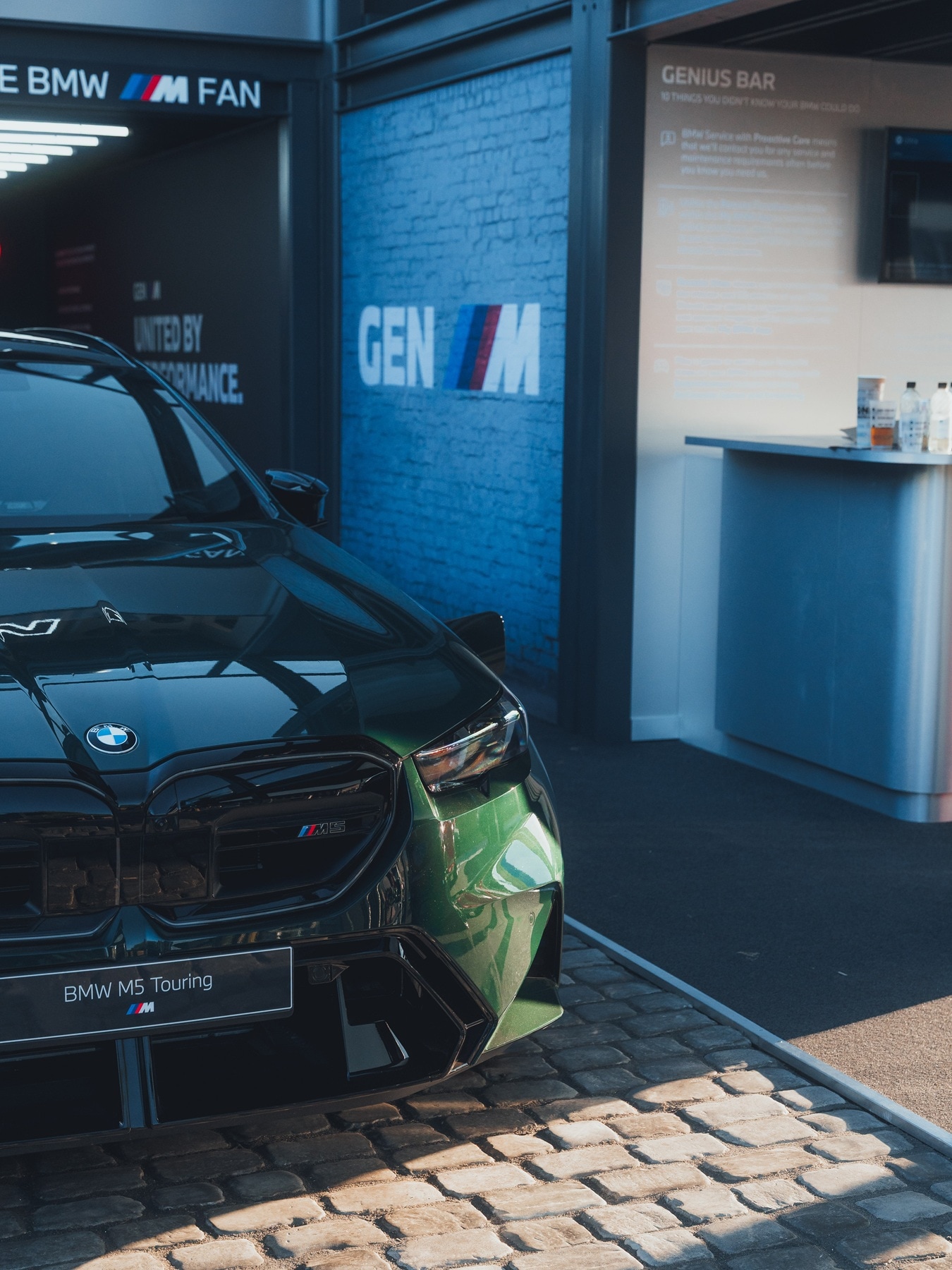 BMW M2 CS parked underneath a GEN-M-Logo at Goodwood.