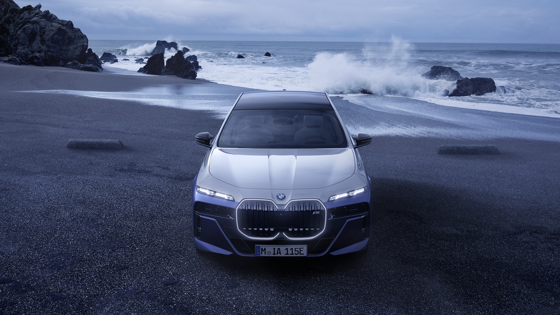 BMW i7 M70 xDrive on a beach.