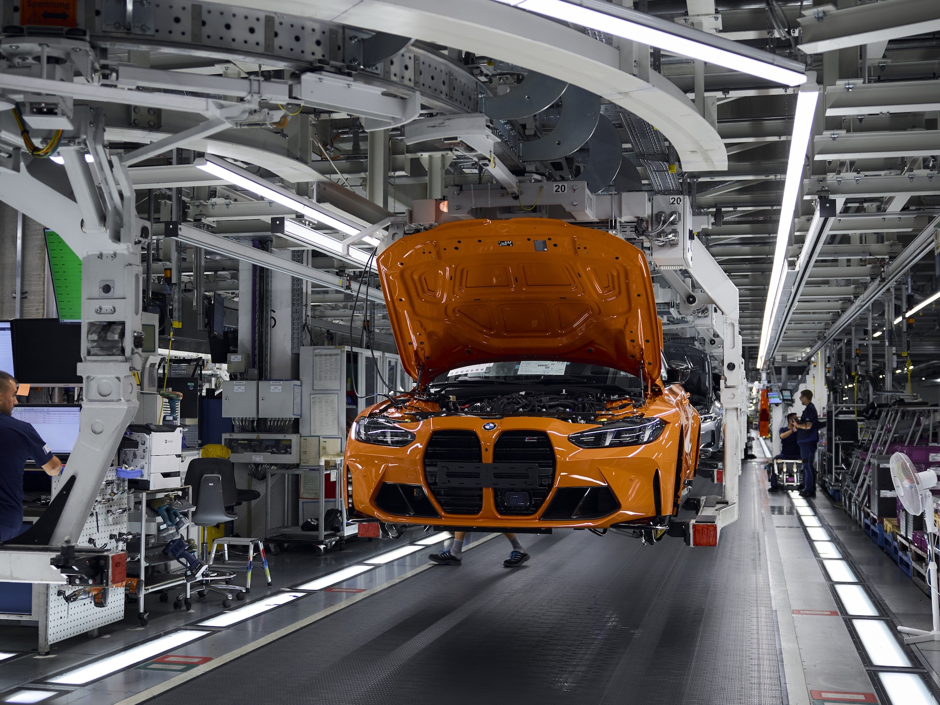 The anniversary car BMW M3 in Fire Orange during assembly in the BMW plant in Munich.