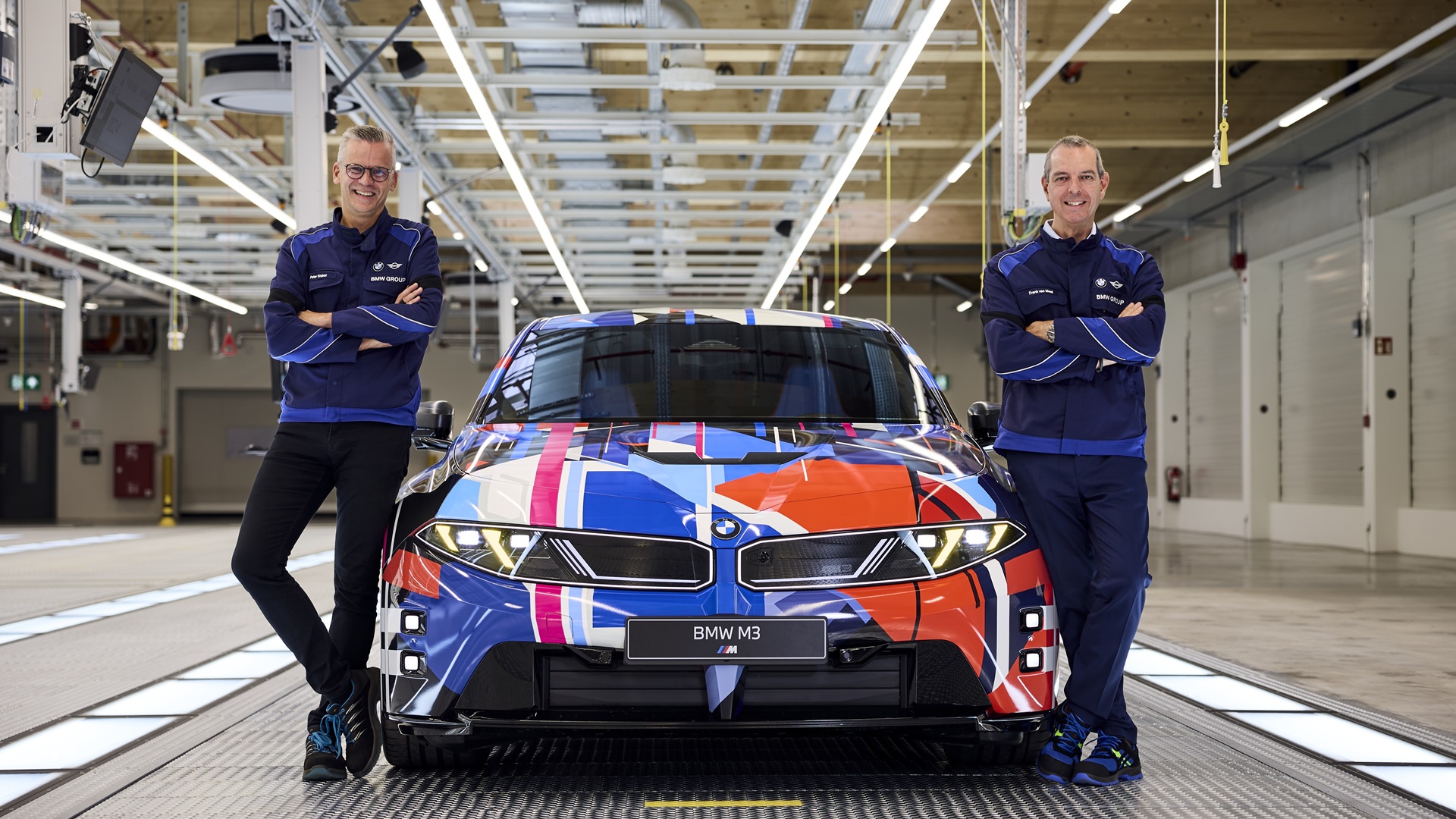Peter Weber and Franciscus van Meel next to a pre-production modell of the fully-electric BMW M3.
