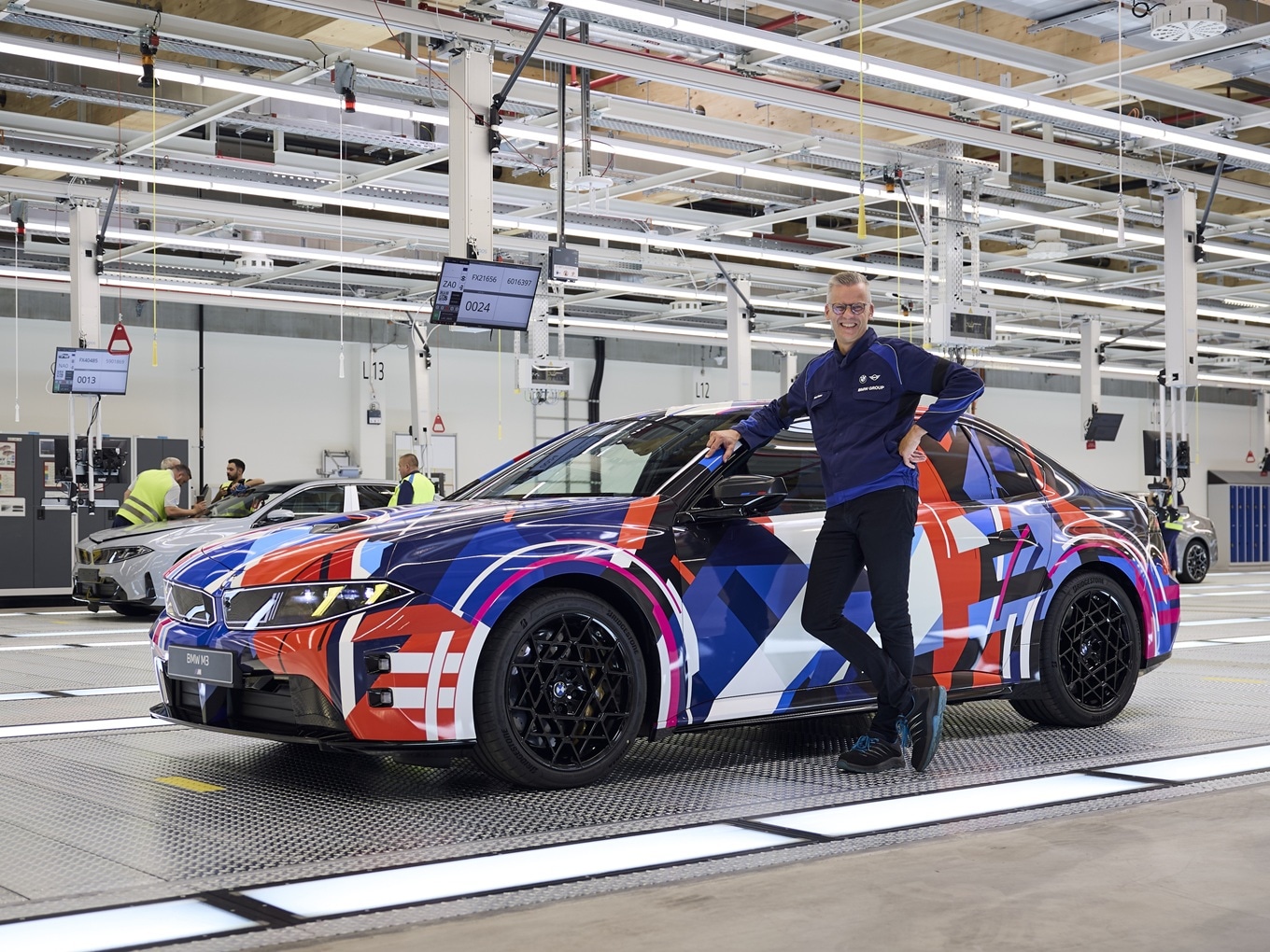 Peter Weber, Head of the BMW Group plant Munich, next to a pre-production model of the all-electric BMW M3.