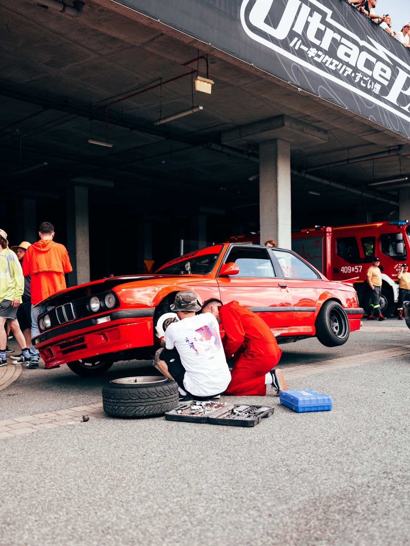 A customised M3 E30 is being prepared for a drift race.