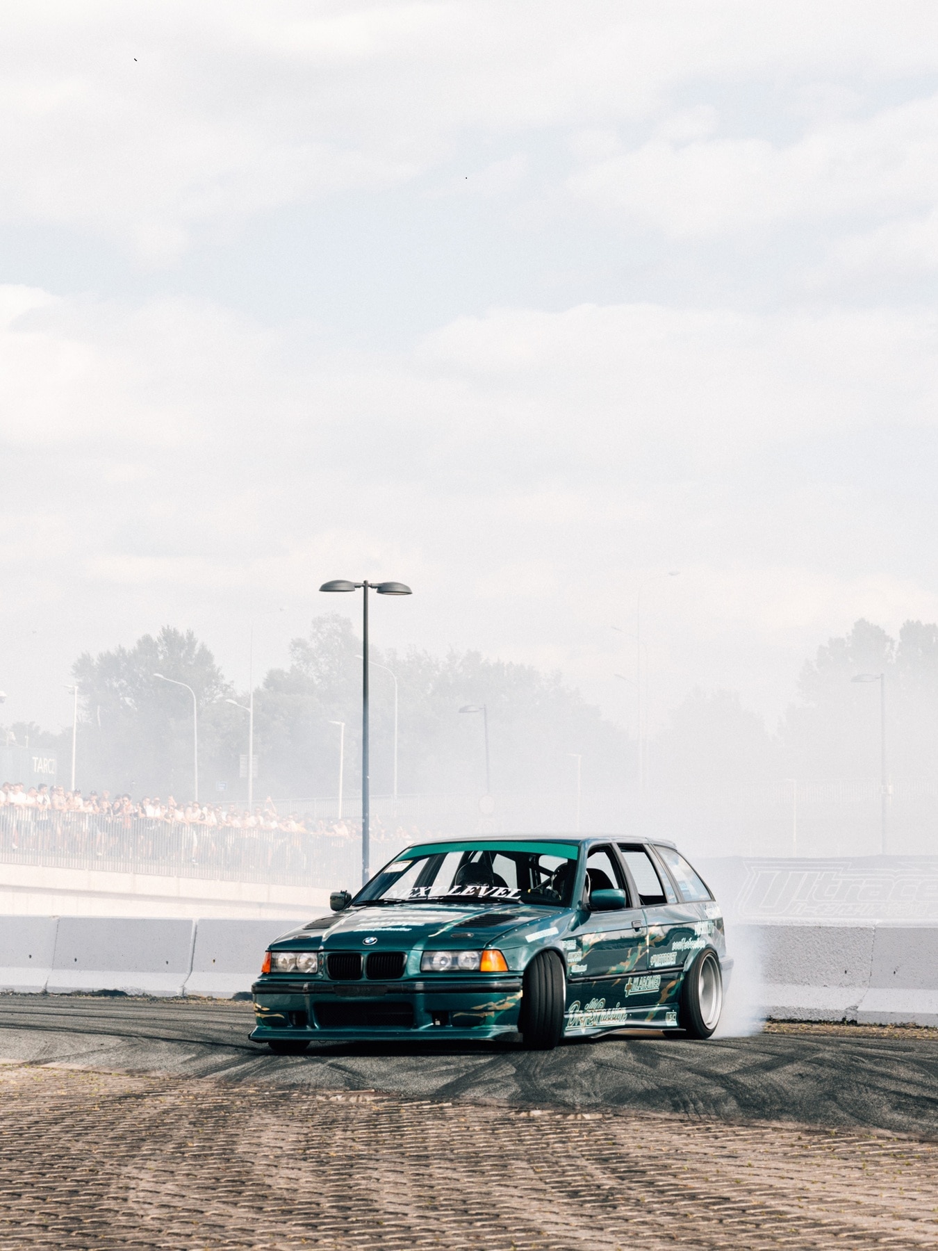 A custom-built BMW 3 Series Touring E36 drifting at Ultrace.
